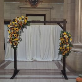 Sunflower floral arch with white daisies on a wooden frame