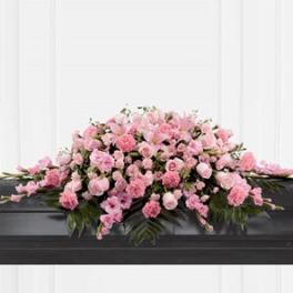 Pink floral casket spray with roses and carnations
