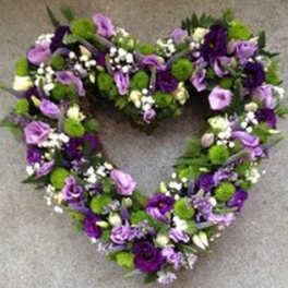 Heart-shaped floral wreath in purple, lavender, white, and green