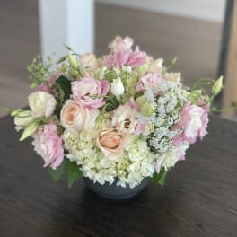 Pink and cream bouquet in a dark vase
