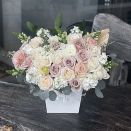 Blush and ivory rose bouquet in a white box vase