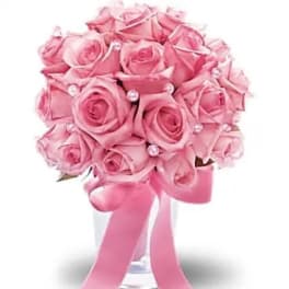 Pink rose bouquet in a clear vase with a long pink ribbon