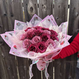 Pink rose bouquet wrapped in Hello Kitty paper with ribbon