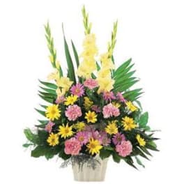 Pink and yellow mixed flower arrangement in a white container