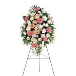 Standing floral spray with pink and white flowers on an easel
