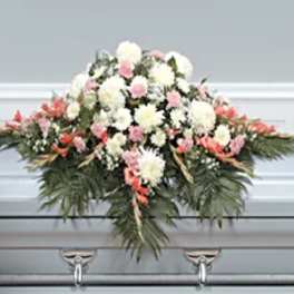 Casket spray with white and pink flowers and greenery
