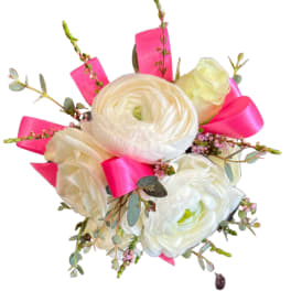 White and blush ranunculus bouquet with bright pink ribbon accents