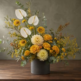 Yellow and white floral arrangement in a gray vase