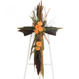 Tall floral standing spray with orange roses on a white easel