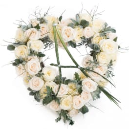 Heart-shaped bouquet of cream roses with muted greenery