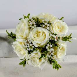 Cream rose bouquet with small white filler flowers and green accents
