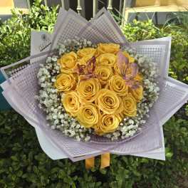 Bouquet of yellow roses with baby's breath in lavender wrap