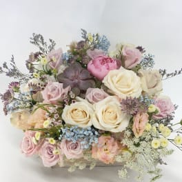 Pastel rose bouquet with a succulent in a wooden box