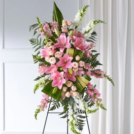 Tall pink and white floral standing arrangement on an easel