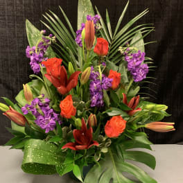 Tropical bouquet with orange roses, lilies, and purple flowers