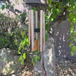 Wind chime hanging from a tree branch outdoors
