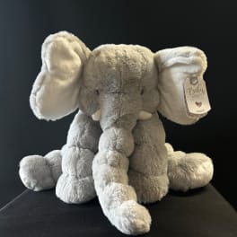 Gray plush elephant toy with oversized ears and a hanging tag