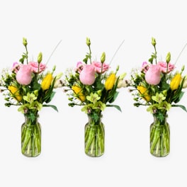 Pink and yellow mixed flower bouquet in a glass vase