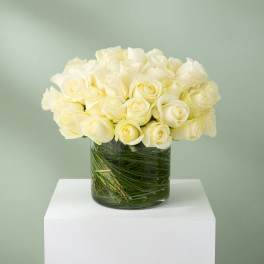 White rose bouquet in a clear glass vase
