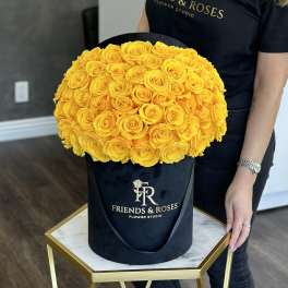Large bouquet of yellow roses in a black hatbox