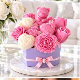 Pink and cream flower-shaped candles in a lavender gift box with a teddy bear candle
