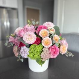 Pink and peach mixed bouquet in a white vase