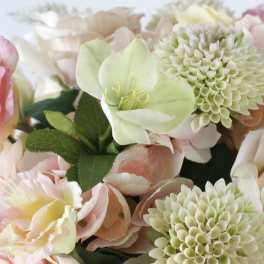 Pastel floral arrangement with pale pink and cream blooms and green-centered flowers
