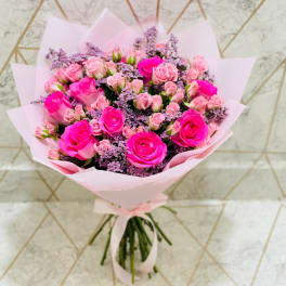 Bouquet of pink roses wrapped in pale pink paper