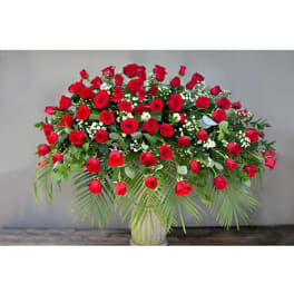 Large arrangement of red roses in a glass vase