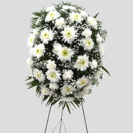White chrysanthemum standing spray on an easel with baby's breath