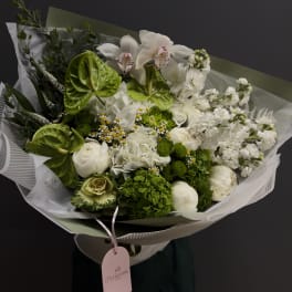 Bouquet of white flowers with bright green anthuriums and wrapped paper