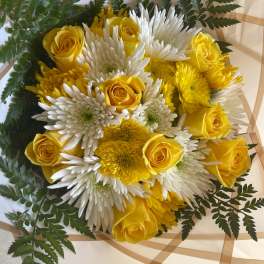 Yellow roses and white chrysanthemums in wrapped bouquet