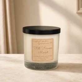 Glass jar candle with a black lid and fall-themed label