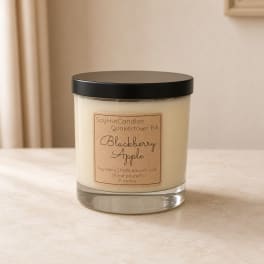 Blackberry Apple soy candle in a clear glass jar with a black lid