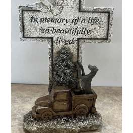 Memorial cross with a dove and truck figurine