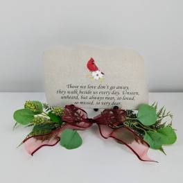 Memorial stone with a red cardinal and floral decoration