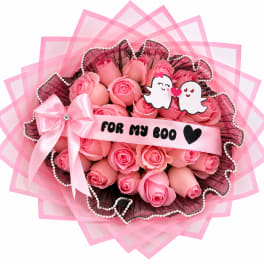Pink rose bouquet with a satin bow and cartoon ghost toppers
