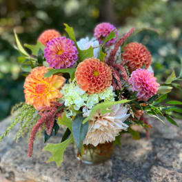 Mixed bouquet of dahlias and hydrangeas in a glass vase