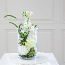White floral arrangement in a clear glass vase