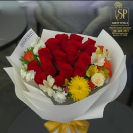 Bouquet of red roses with yellow and white flowers wrapped in white paper