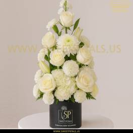White roses and mums arranged in a black box vase
