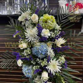 Standing floral spray with white, blue, and purple flowers