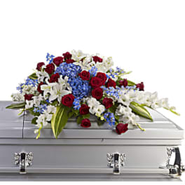 White , blue and red casket spray