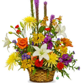 Colorful mixed arrangement of lilies, roses, and mums in a woven basket