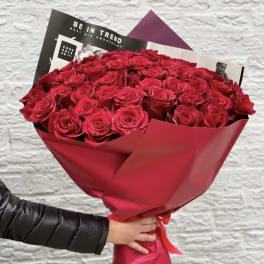 50 red roses wrapped bouquet. The photo shows a standard size.