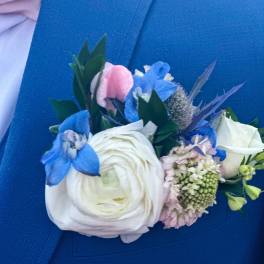 Blue and white boutonniere with a large white bloom