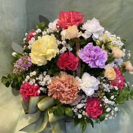 Colorful bouquet of carnations and baby's breath with a ribbon bow