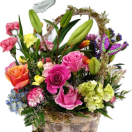 Mixed flower basket with roses, lilies, carnations, and a butterfly pick