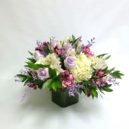 Mixed pastel bouquet in a dark square vase