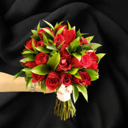 Bouquet of red roses with green foliage